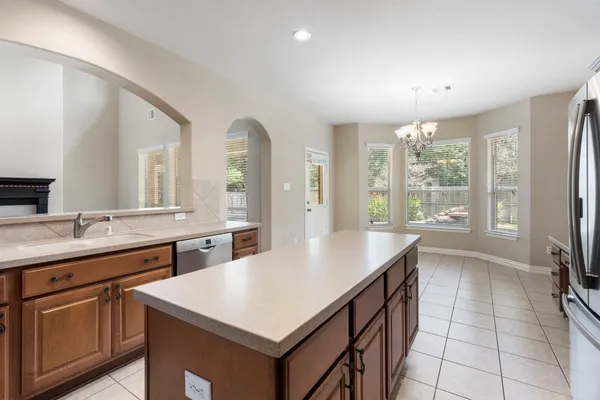a kitchen with a stove a sink a refrigerator and a microwave
