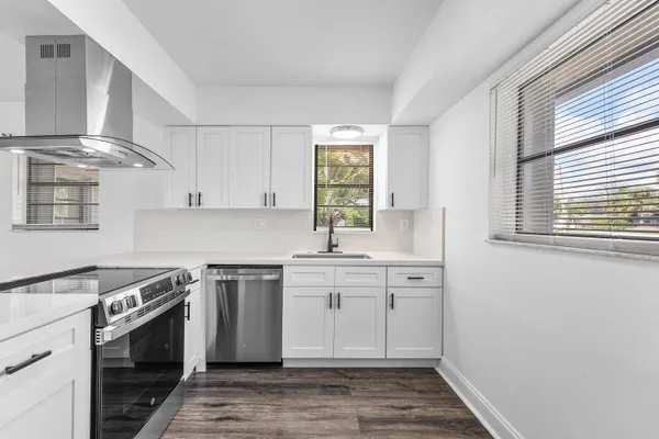 a kitchen with stainless steel appliances granite countertop a sink and a stove