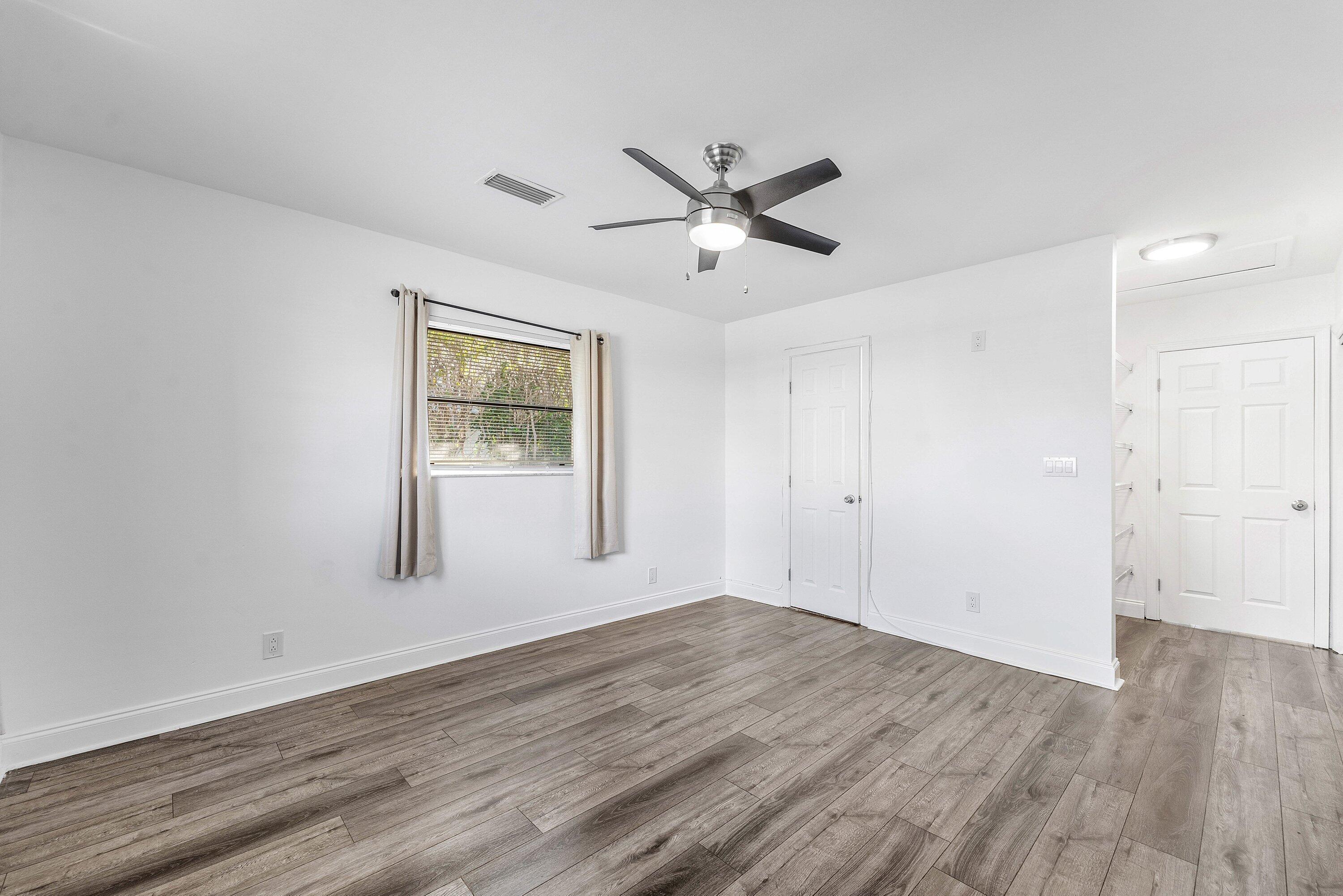500 Northeast 48th Street Boca Raton, FL 33431 - Photo 19 of 30 a view of empty room with wooden floor and fan