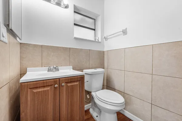 a bathroom with a sink a toilet and a mirror