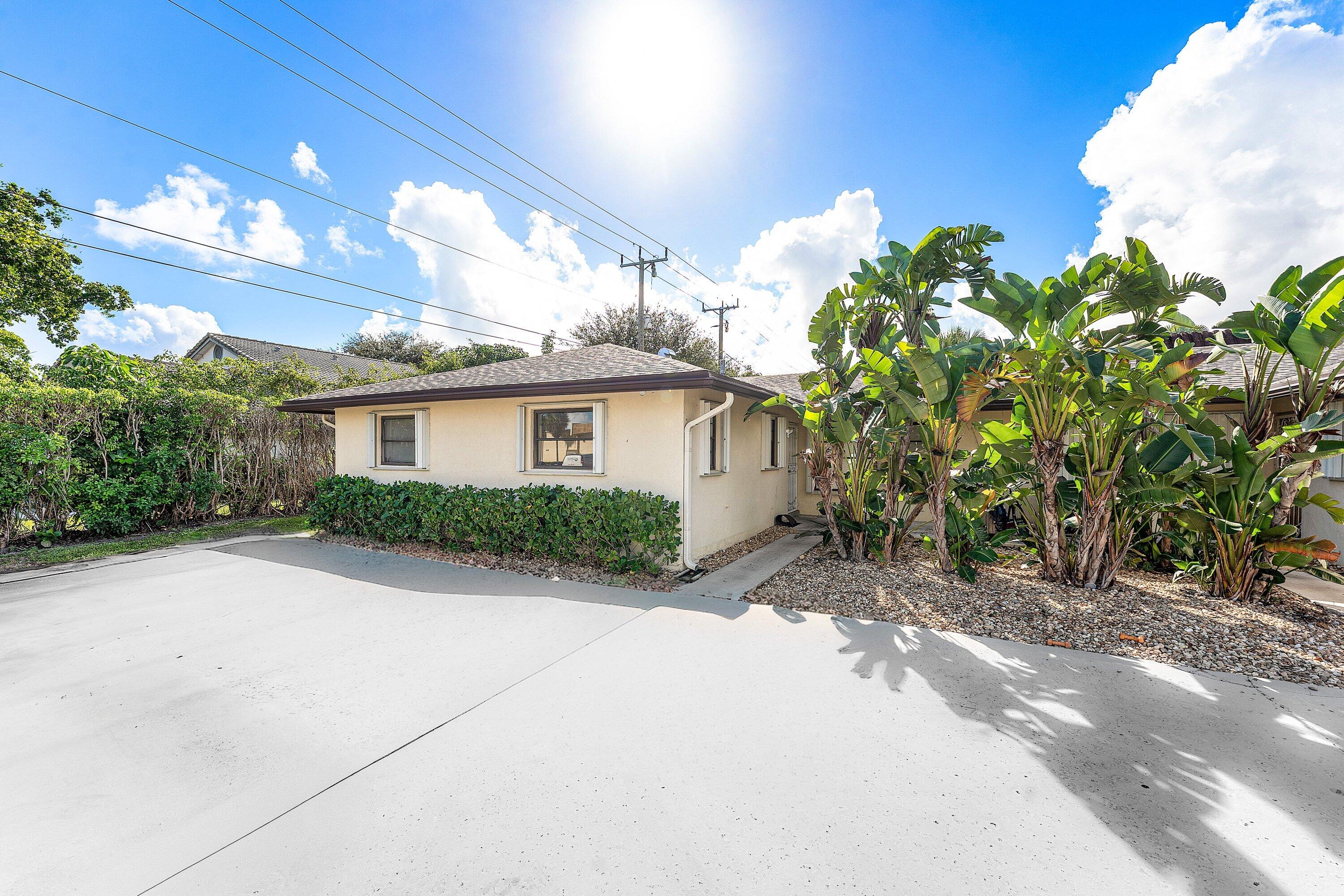 500 Northeast 48th Street Boca Raton, FL 33431 - Photo 2 of 30 a view of a house with a yard