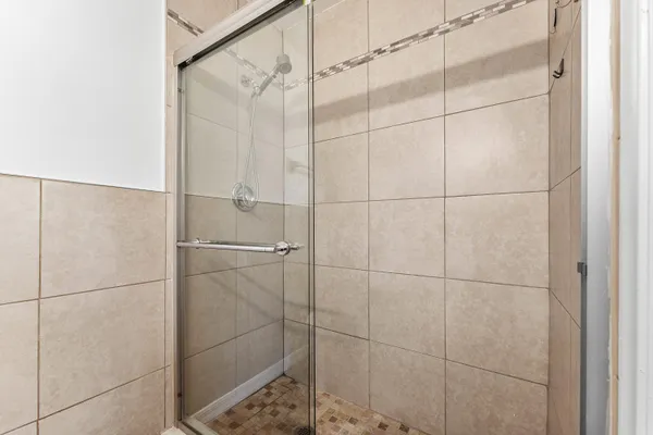 a bathroom with a glass shower door