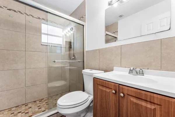 a bathroom with a sink toilet and shower