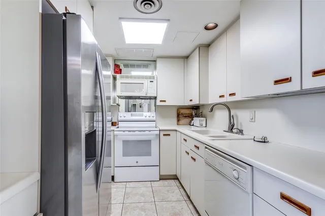 a view of a swimming pool with outdoor seating and plants