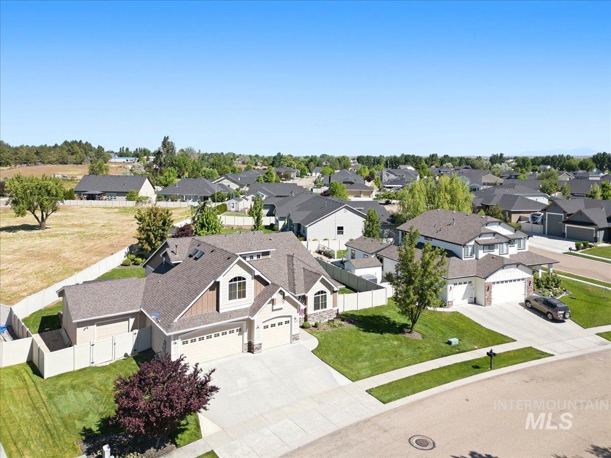 1183 North Buffalo Way Middleton, ID 83644 - Photo 2 of 47 Contemporary residence featuring a paved driveway, attached garages, and a manicured lawn