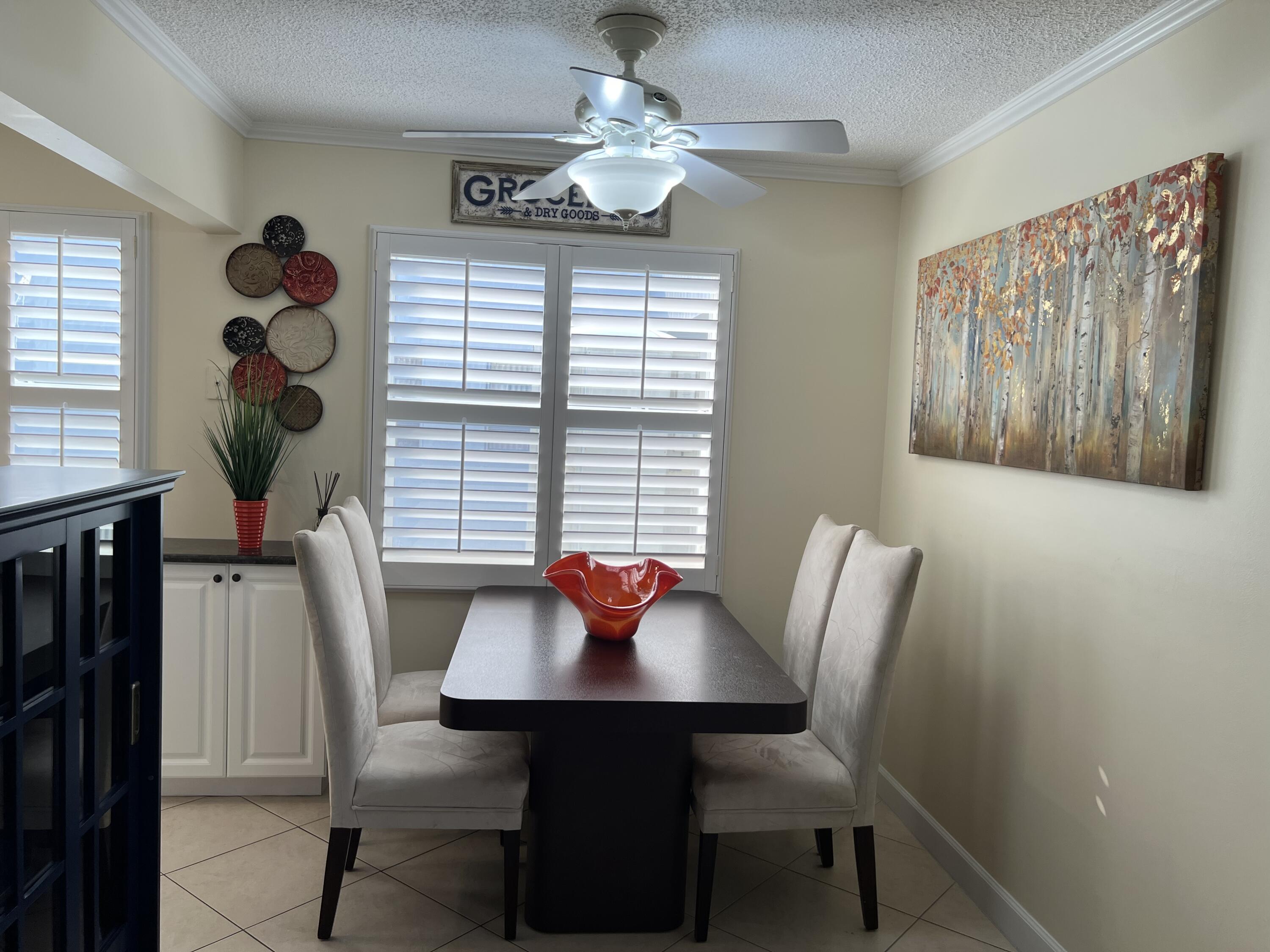 183 Normandy Lane Delray Beach, FL 33484 - Photo 27 of 80 a view of a dining room with furniture window and outside view