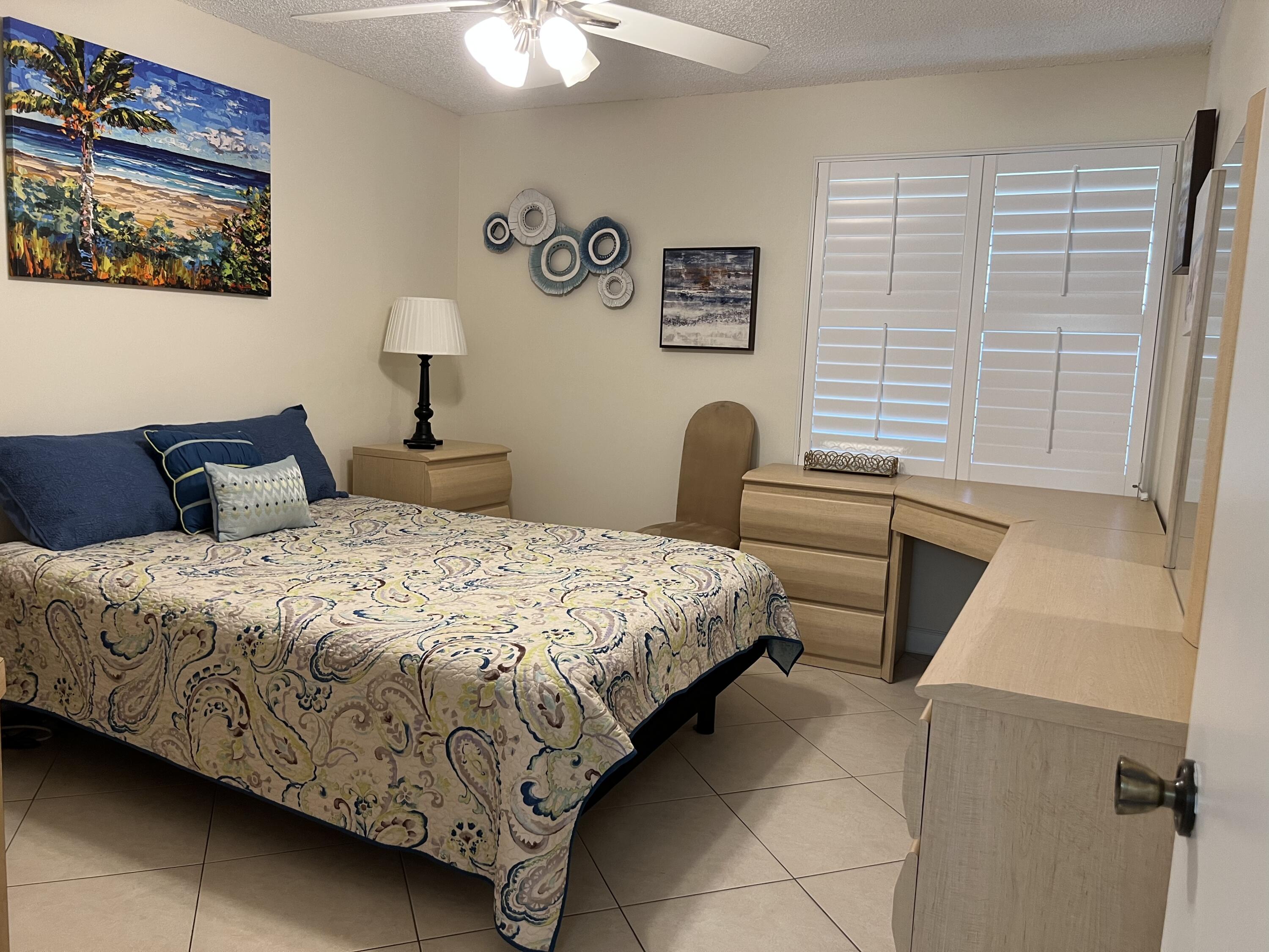 183 Normandy Lane Delray Beach, FL 33484 - Photo 30 of 80 a bedroom with a bed and a window