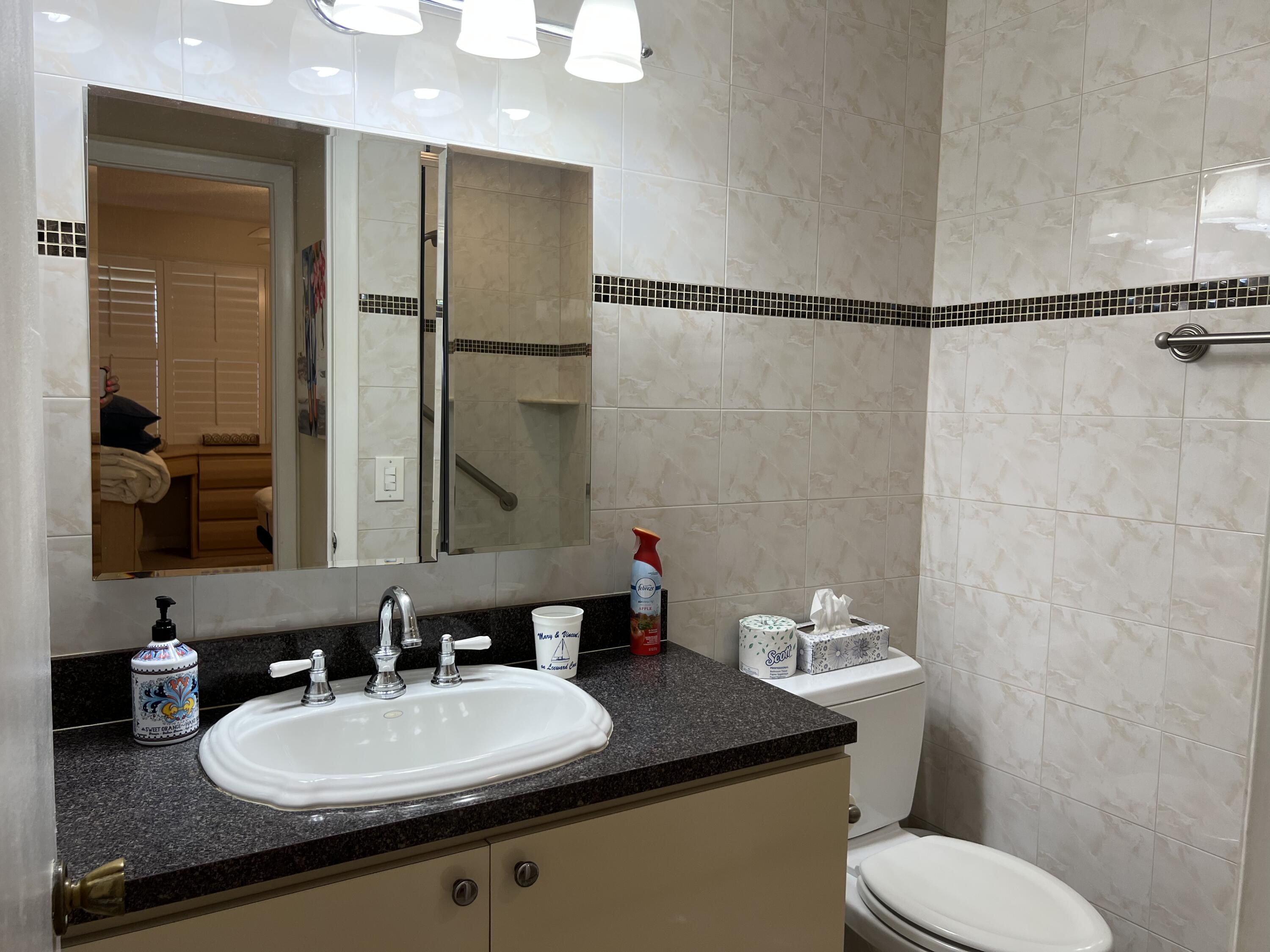 183 Normandy Lane Delray Beach, FL 33484 - Photo 37 of 80 a bathroom with a granite countertop sink toilet and shower