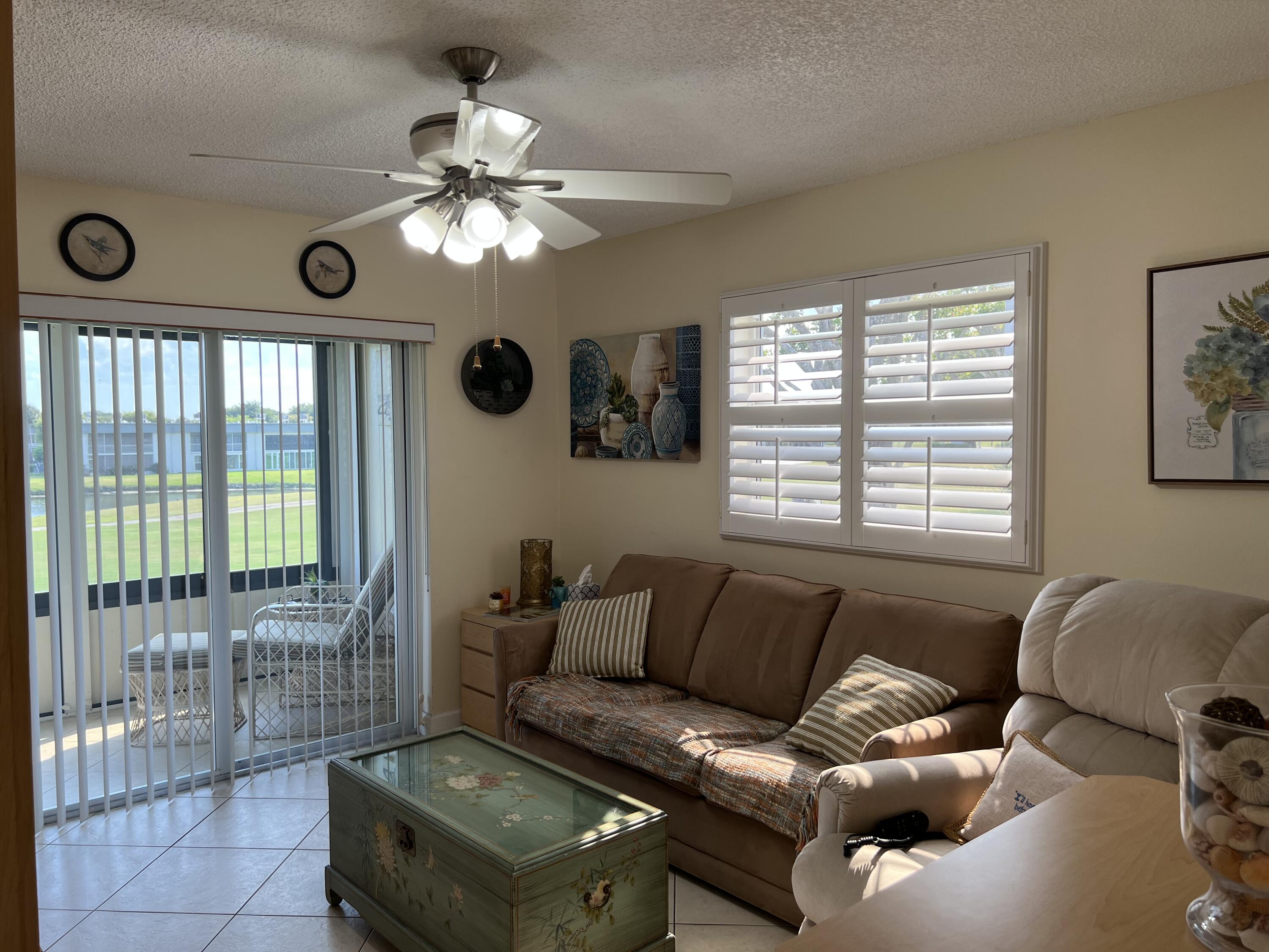 183 Normandy Lane Delray Beach, FL 33484 - Photo 43 of 80 a living room with furniture and a large window