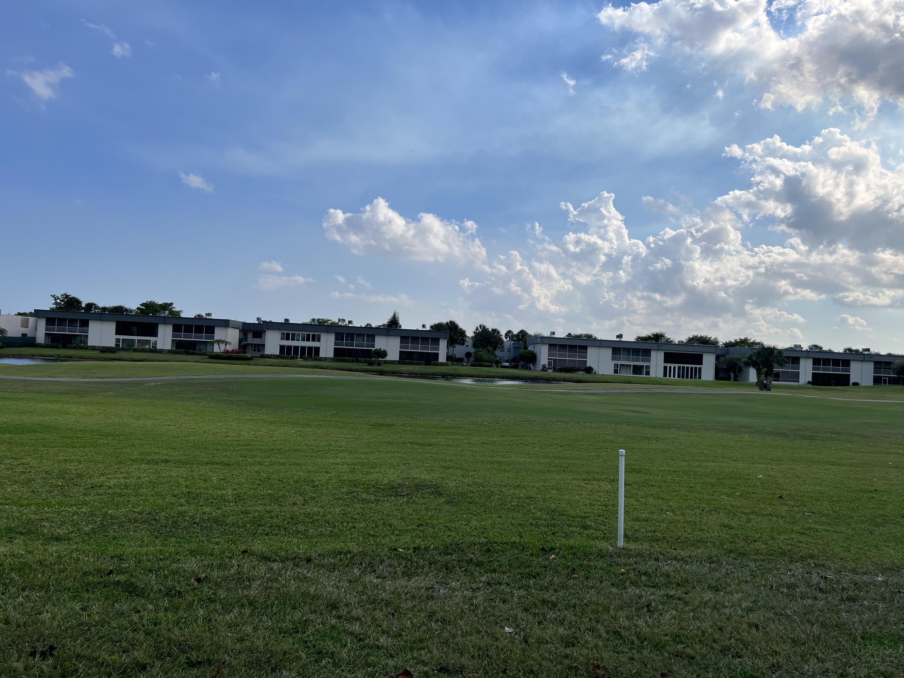 183 Normandy Lane Delray Beach, FL 33484 - Photo 55 of 80 a view of a golf course with a lake
