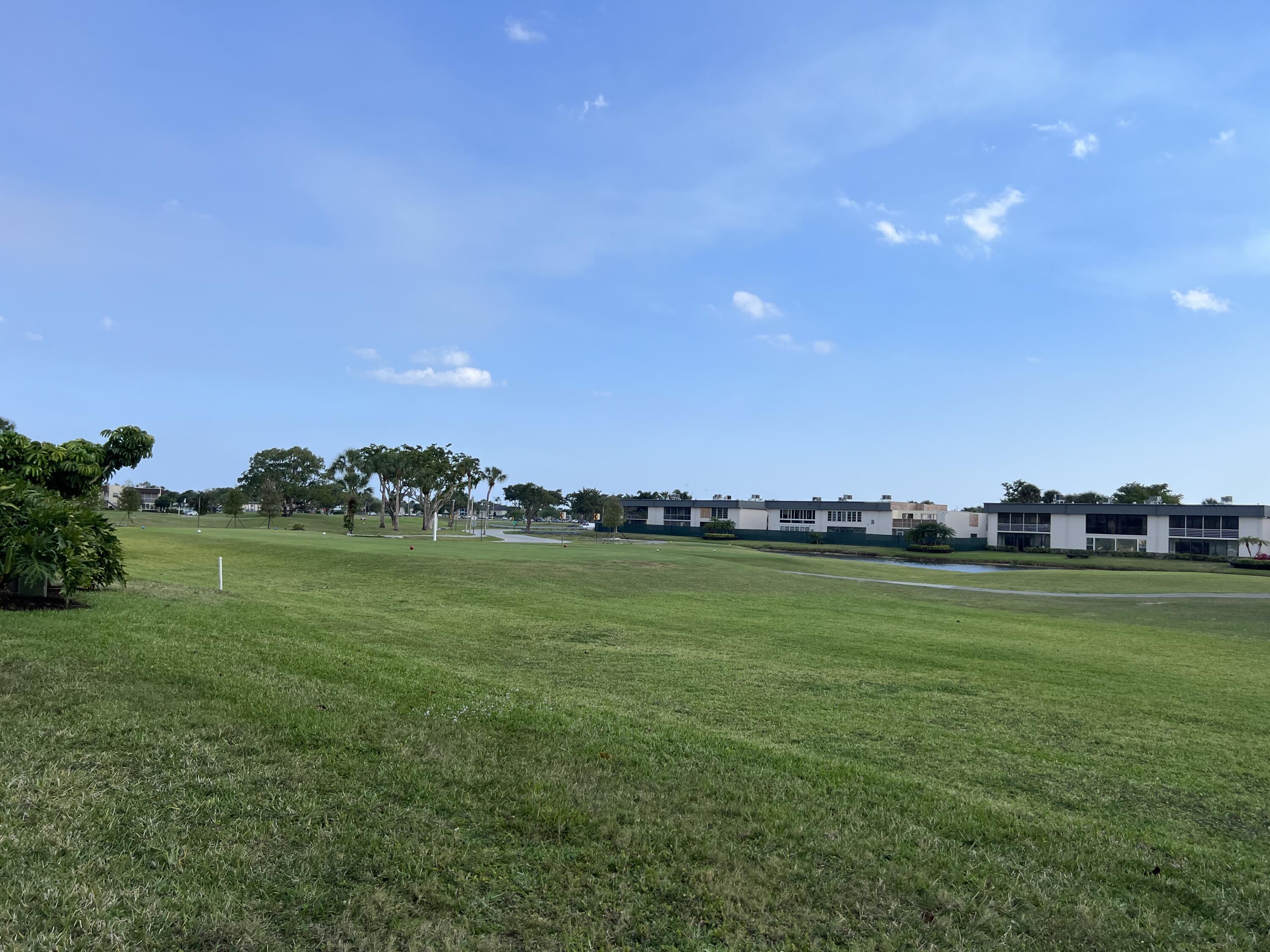 183 Normandy Lane Delray Beach, FL 33484 - Photo 8 of 80 a view of a golf course with a lake