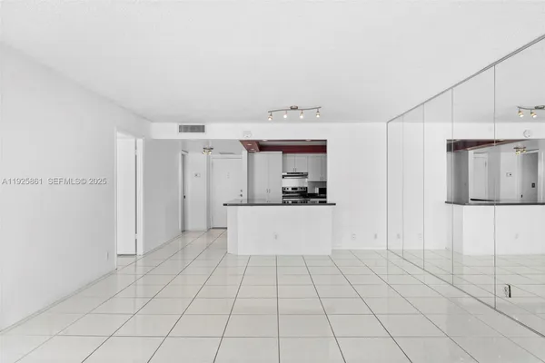 a large white kitchen with cabinets