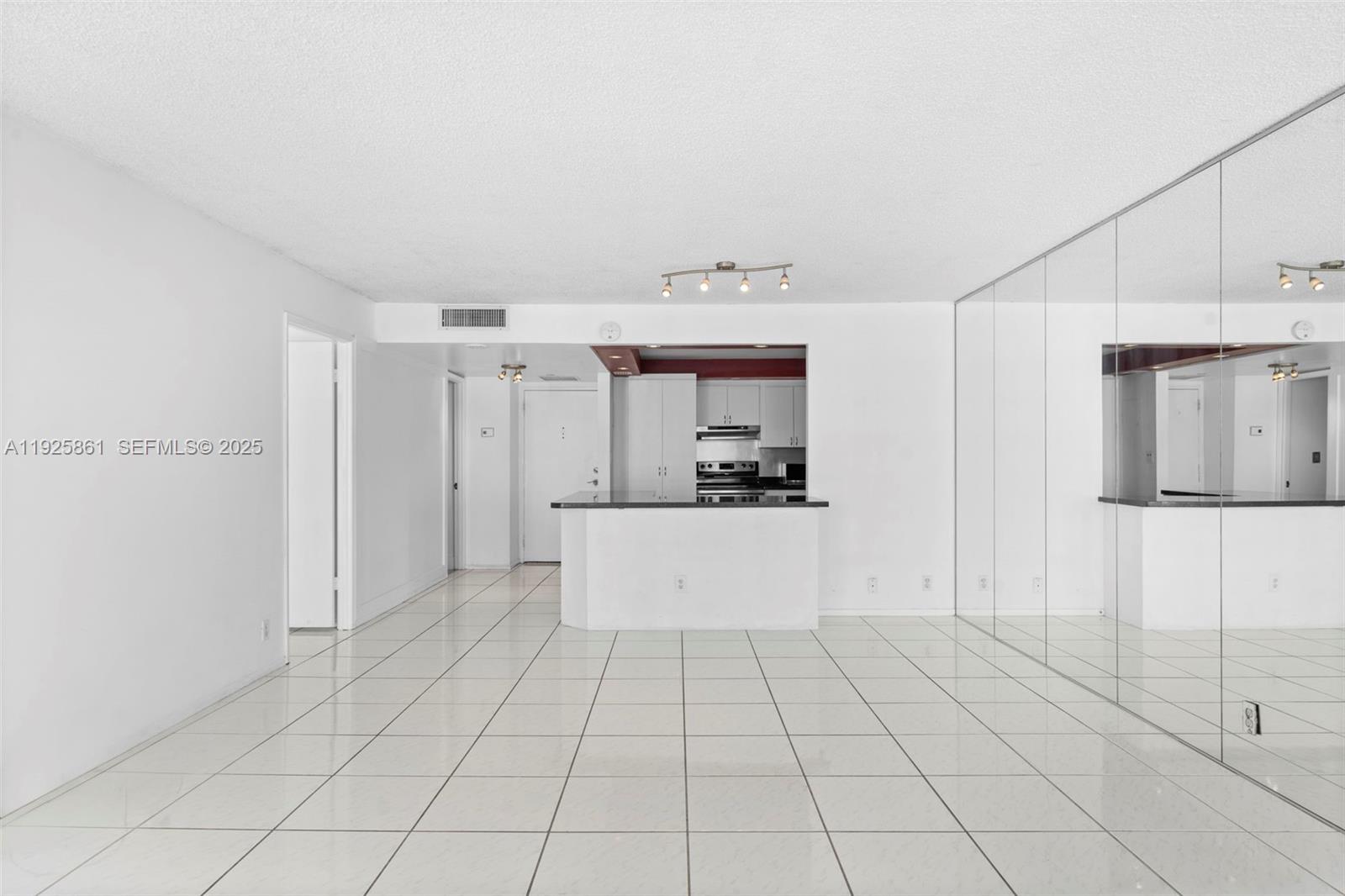 1865 Brickell Avenue, Unit A1102 Miami, FL 33129 - Photo 3 of 4 a large white kitchen with cabinets
