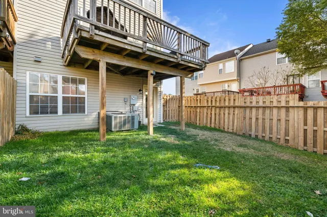 a view of a house with a yard and deck