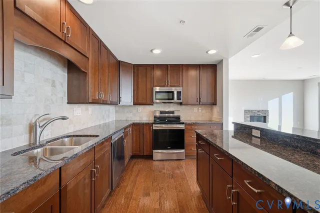 a view of empty room with wooden floor and floor to ceiling window