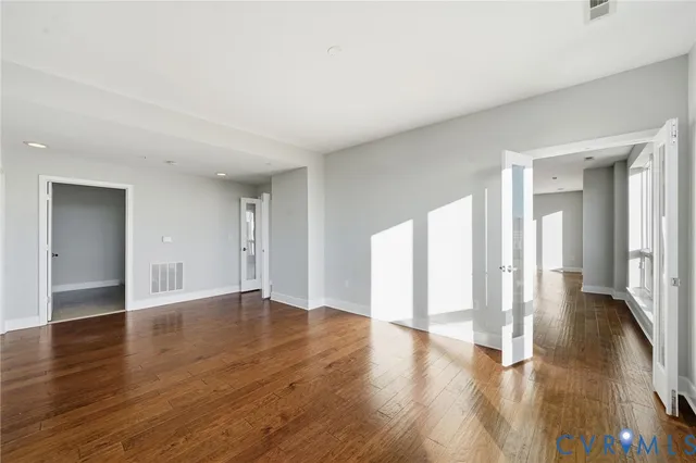 a view of an empty room with a fireplace and a window