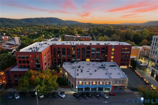 an aerial view of residential houses with city view