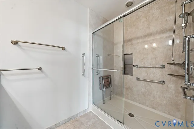 a view of an empty room with wooden floor and windows