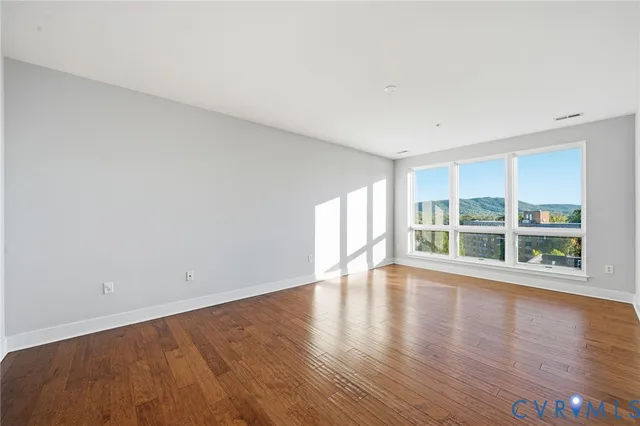 a view of an empty room and wooden floor