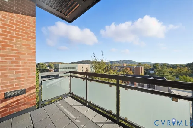 an aerial view of a house with a mountain
