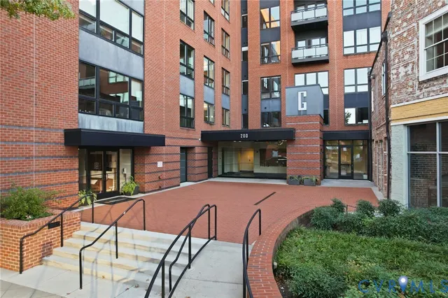 a view of a living room kitchen with a sink and a kitchen island
