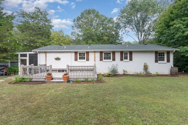a backyard of a house with table and chairs