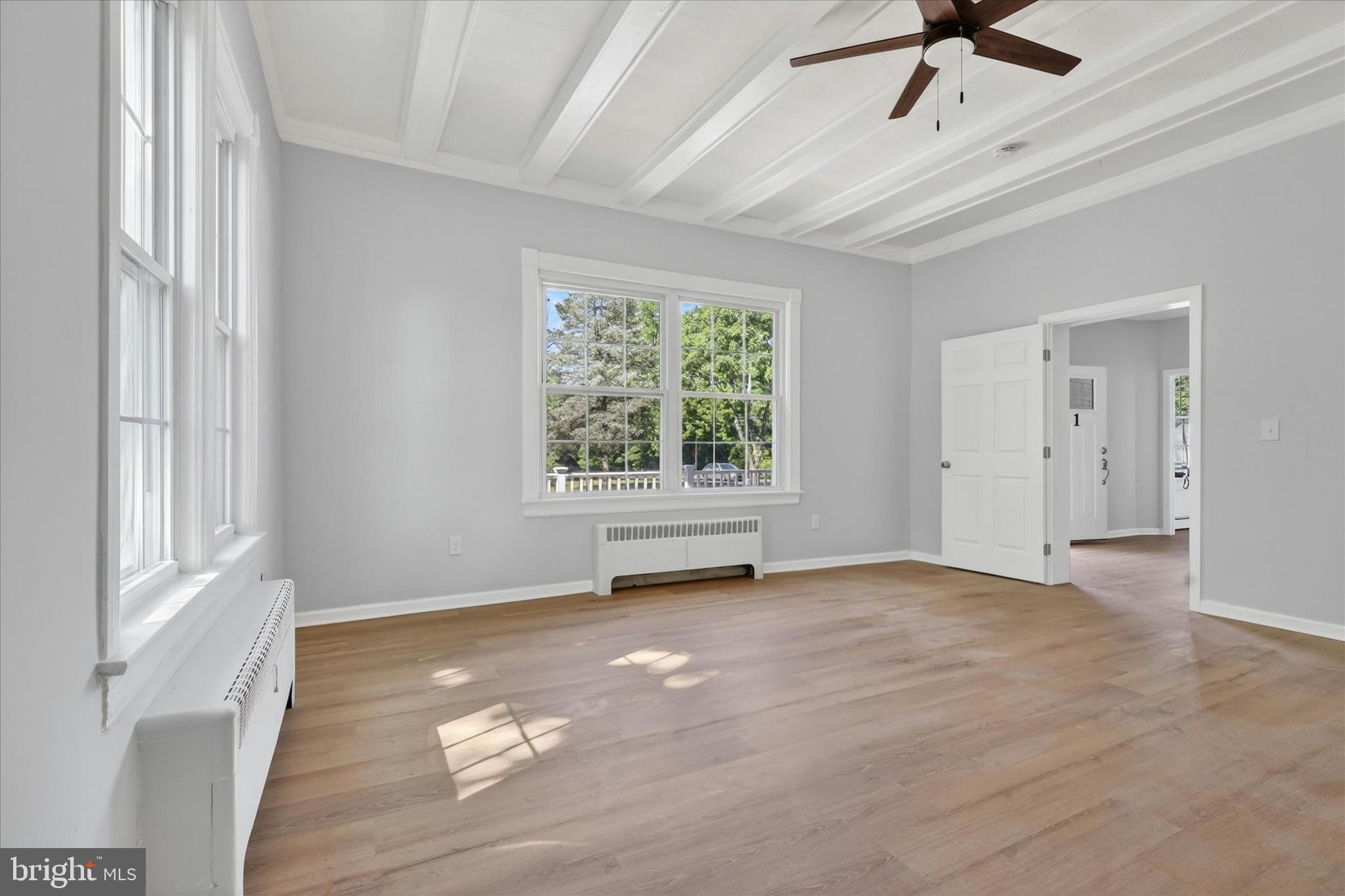 509 Lumberton Road, Unit 1 Hainesport, NJ 08036 - Photo 11 of 33 a view of an empty room with a window and wooden floor