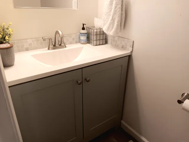 a bathroom with a sink and vanity