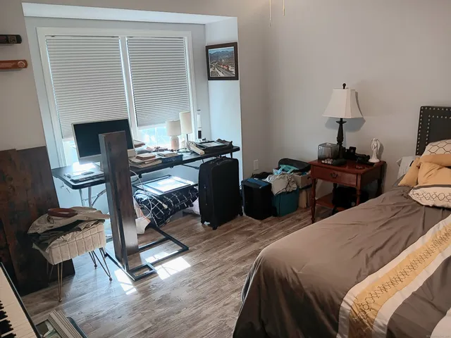 a bedroom with furniture and a wooden floor