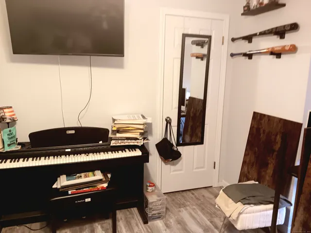 a view of a hallway with wooden floor and a fireplace