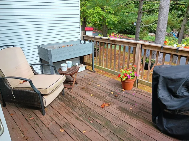 a view of a deck with wooden floor and outdoor seating