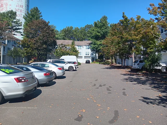 a group of cars parked in a parking lot at street
