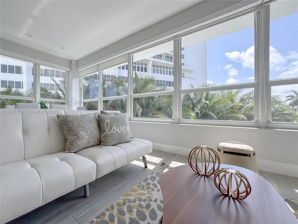 a living room with furniture and a large window