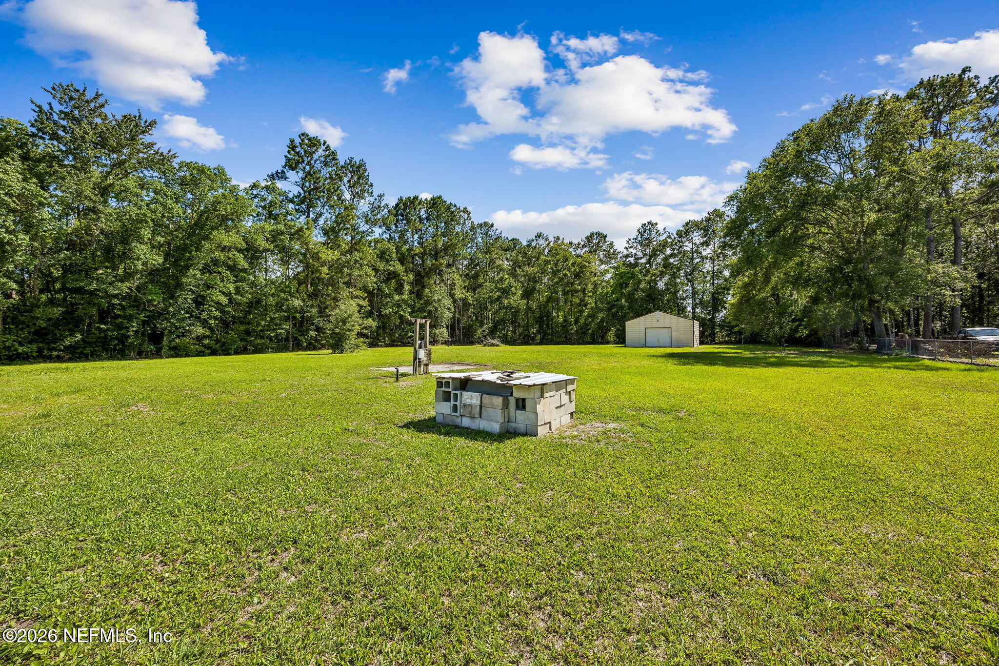 15690 Sears Road Jacksonville, FL 32218 - Photo 24 of 27 a view of a swimming pool with a yard
