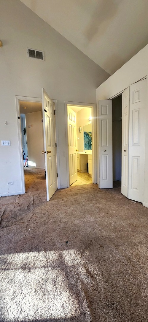 117 Enclave Circle, Unit A Bolingbrook, IL 60440 - Photo 14 of 18 a view of a big room with closet and wooden floor