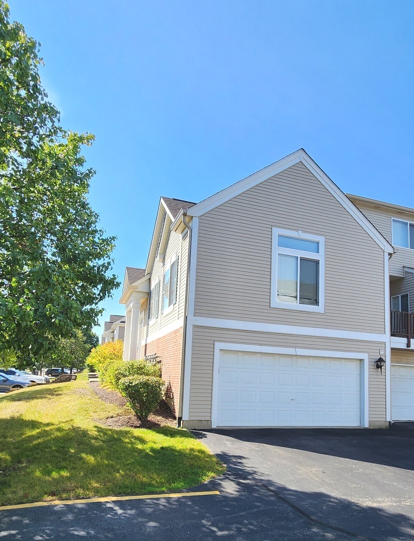 117 Enclave Circle, Unit A Bolingbrook, IL 60440 - Photo 18 of 18 a front view of a house with yard