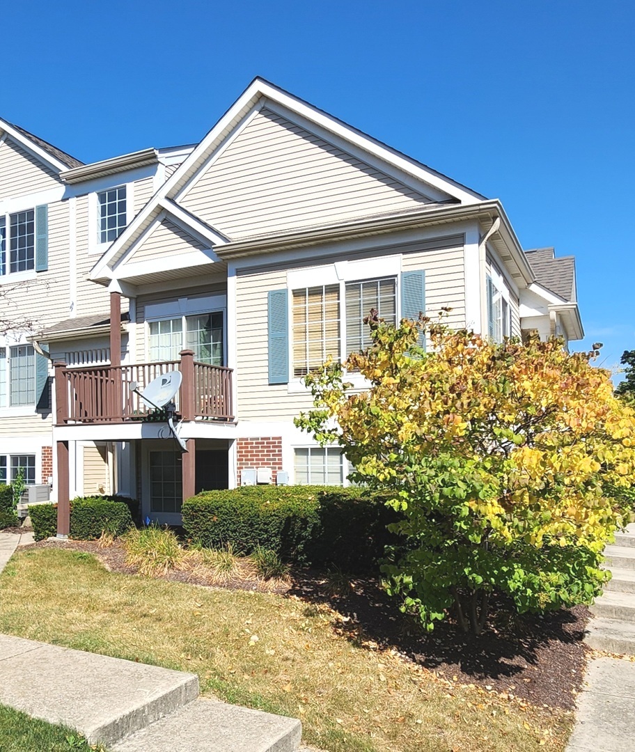 117 Enclave Circle, Unit A Bolingbrook, IL 60440 - Photo 2 of 18 a front view of a house with garden