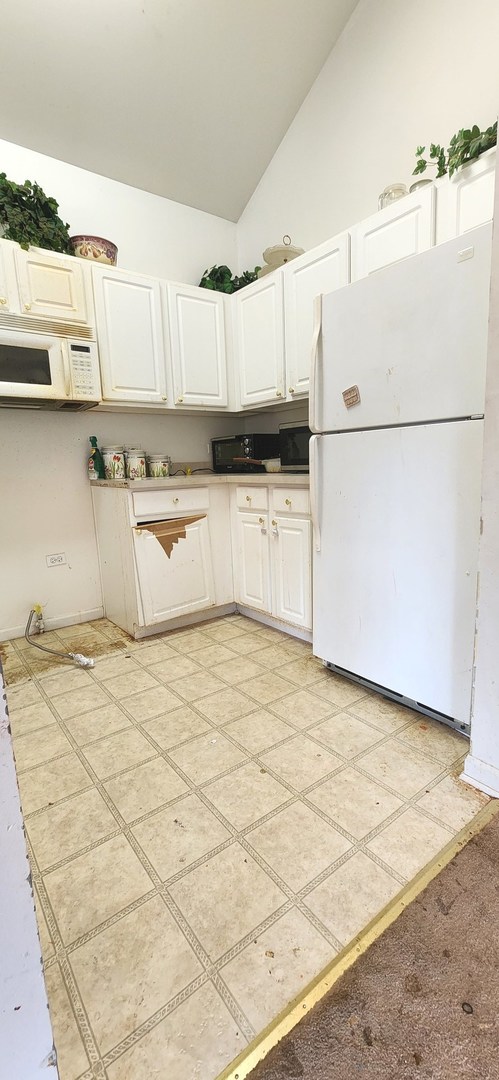 117 Enclave Circle, Unit A Bolingbrook, IL 60440 - Photo 5 of 18 a kitchen with stainless steel appliances a refrigerator sink and white cabinets