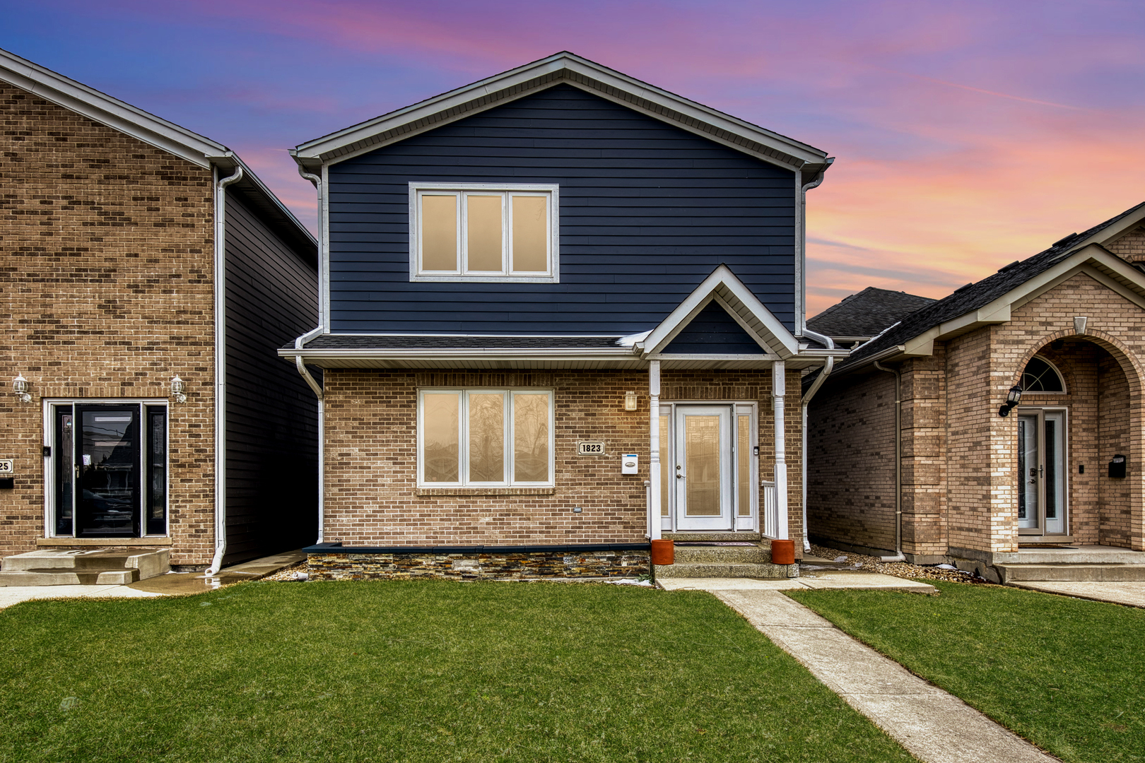 front view of a house with a yard