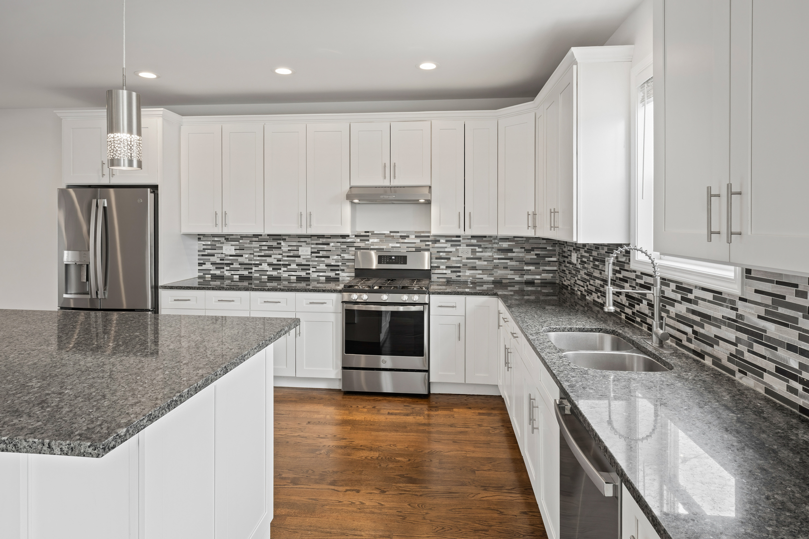 1823 35th Avenue Stone Park, IL 60165 - Photo 12 of 44 a kitchen with granite countertop a sink stainless steel appliances and cabinets