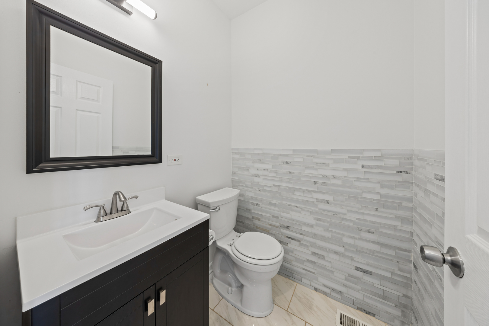 1823 35th Avenue Stone Park, IL 60165 - Photo 17 of 44 a bathroom with a toilet a sink and mirror