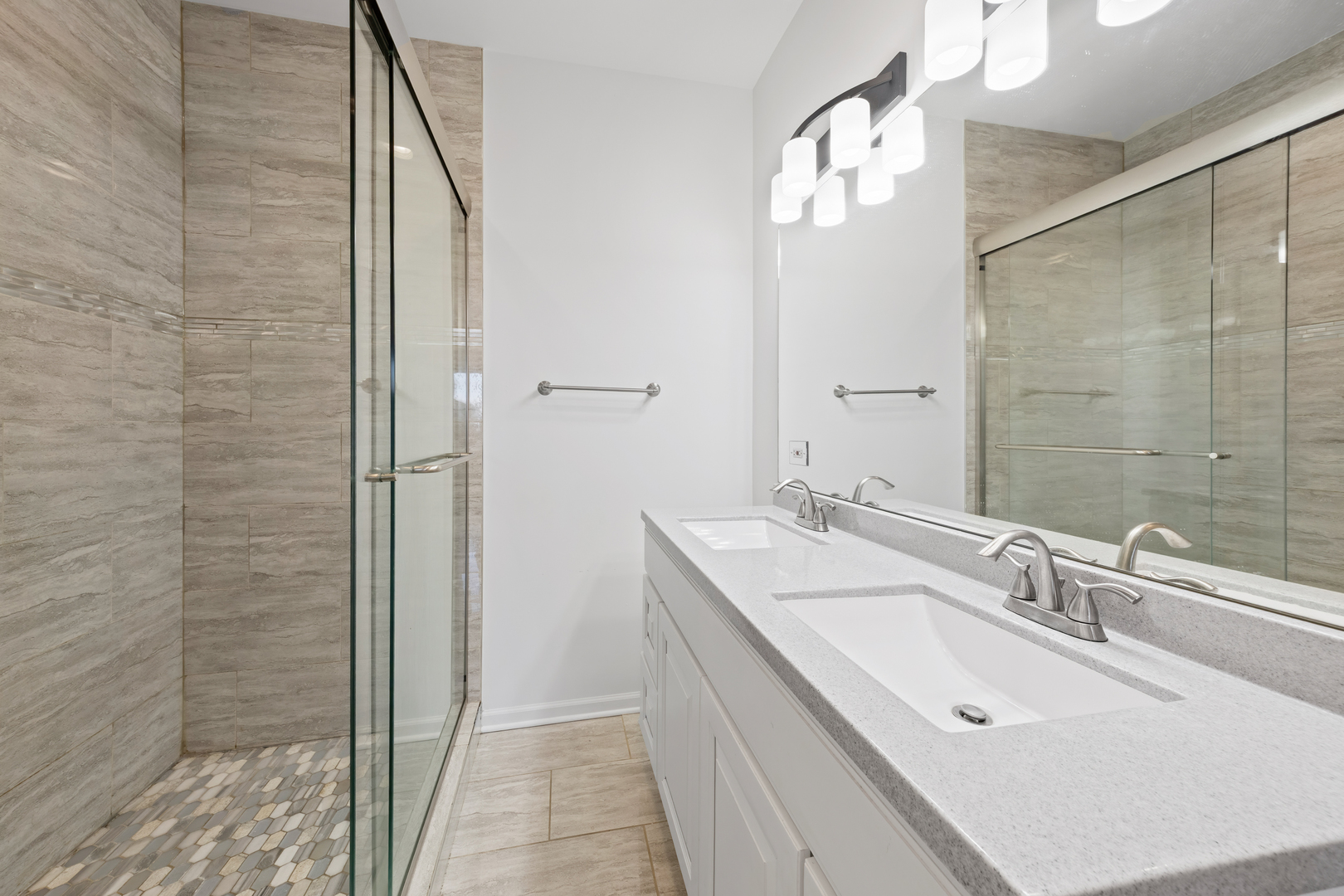 1823 35th Avenue Stone Park, IL 60165 - Photo 22 of 44 a bathroom with a double vanity sink a mirror and a shower