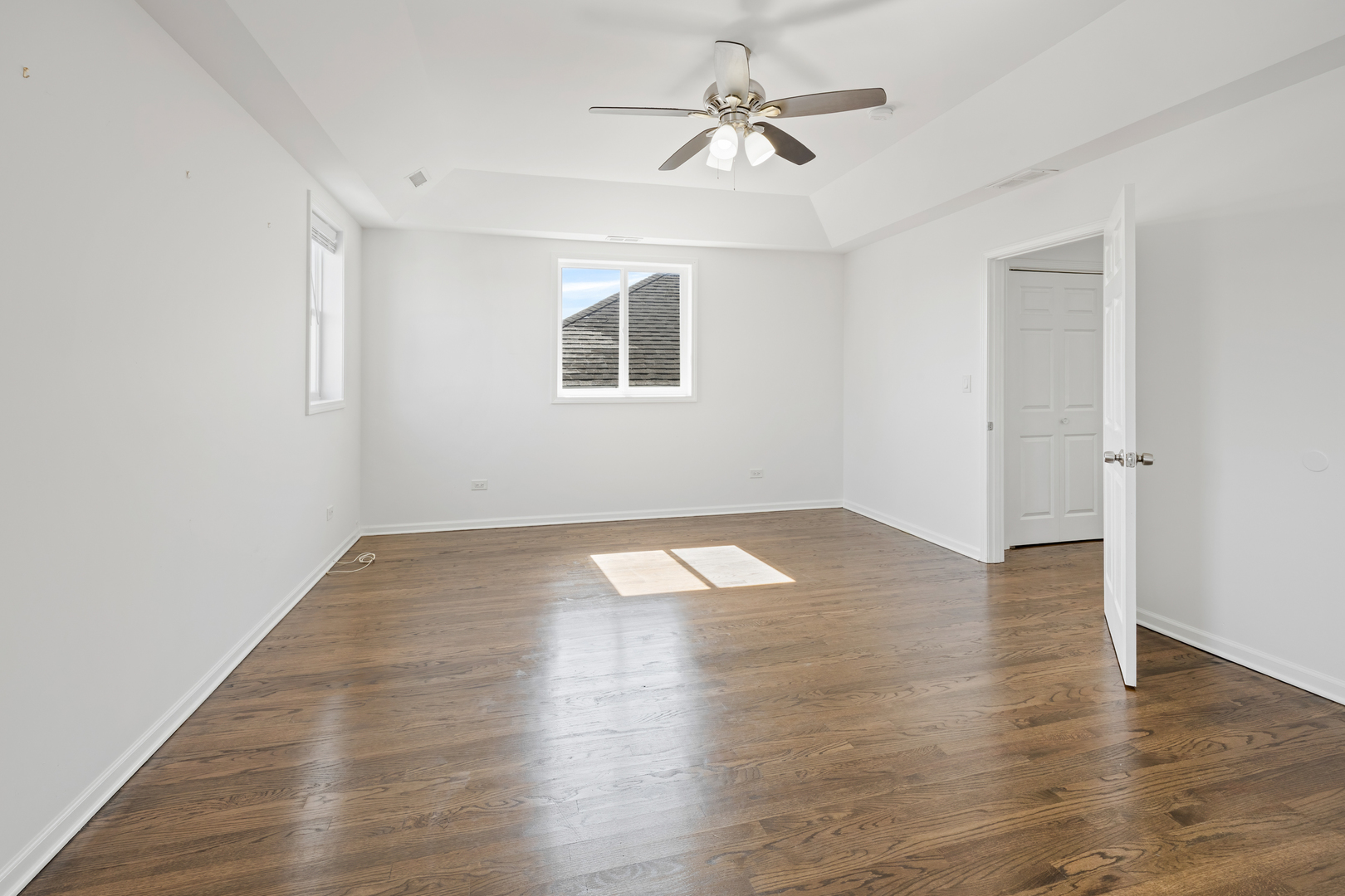 1823 35th Avenue Stone Park, IL 60165 - Photo 25 of 44 an empty room with wooden floor chandelier fan and windows