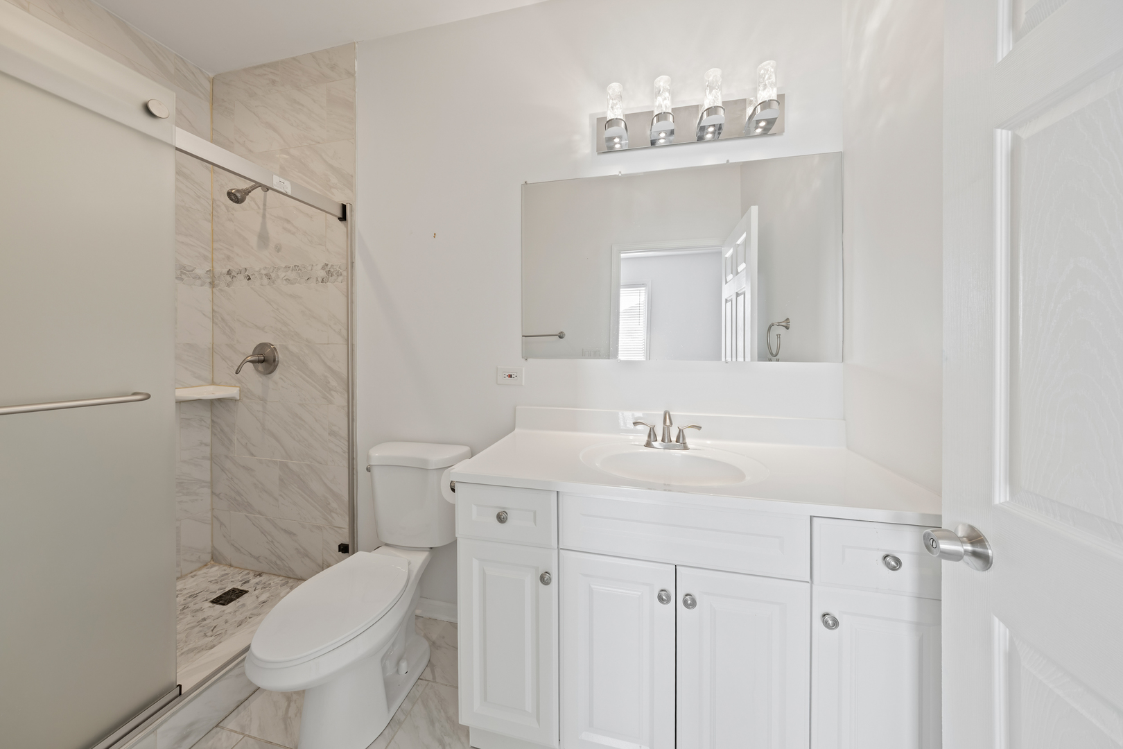 1823 35th Avenue Stone Park, IL 60165 - Photo 28 of 44 a bathroom with a sink a toilet and shower