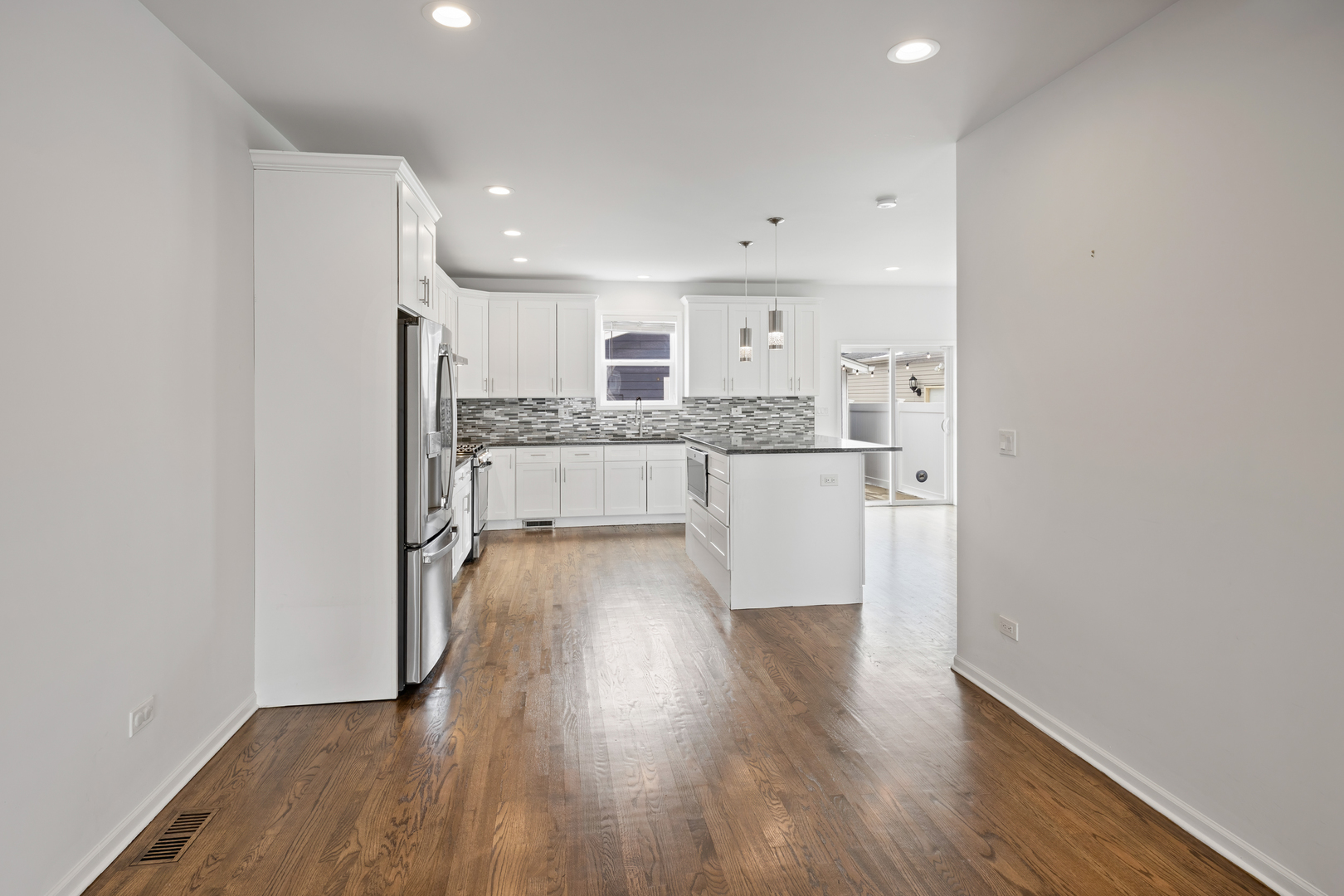 1823 35th Avenue Stone Park, IL 60165 - Photo 9 of 44 a view of a kitchen with wooden floor and a window