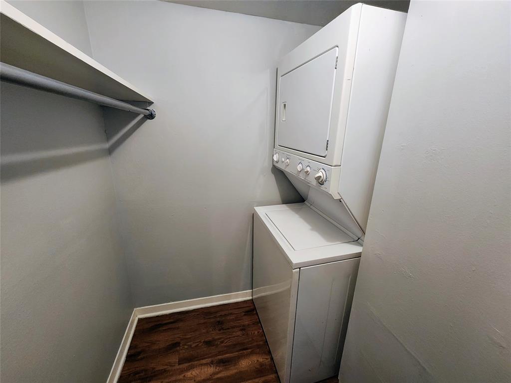 608 West 51st Street, Unit 101 Austin, TX 78751 - Photo 11 of 11 Laundry area with dark wood-style flooring and stacked washer / dryer