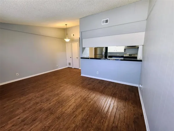 a view of a room with wooden floor