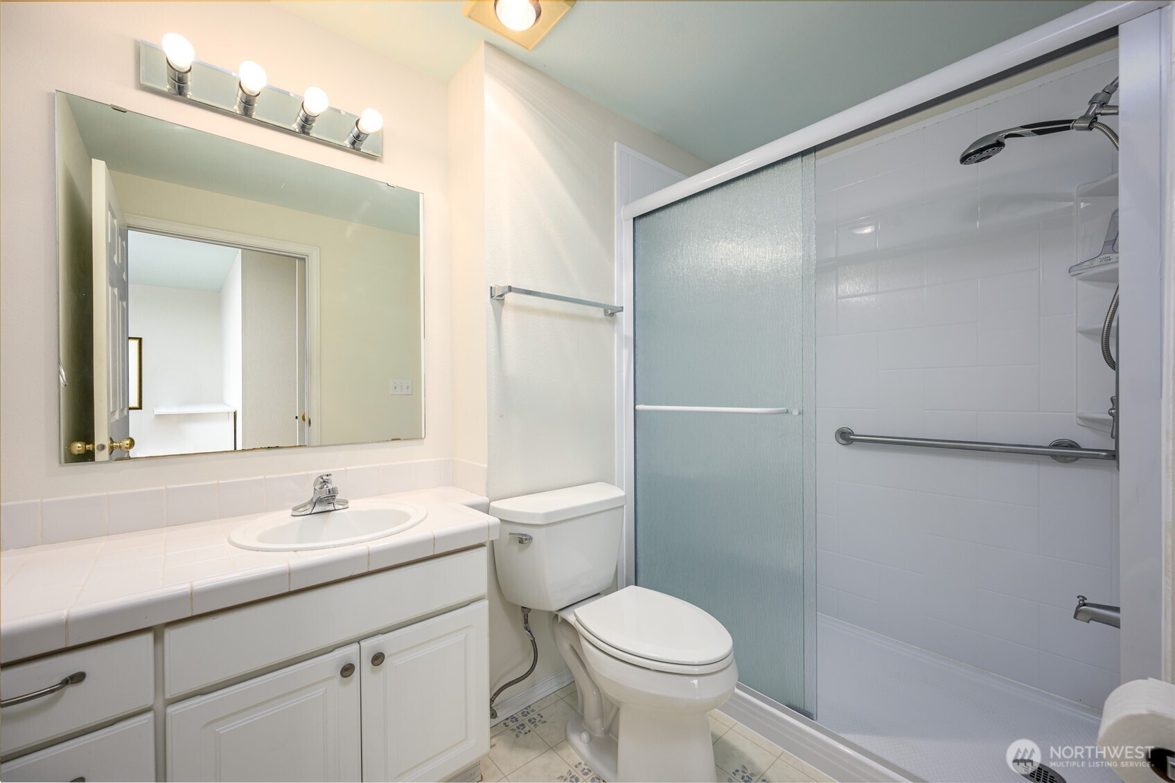 910 34th Street, Unit 202 Anacortes, WA 98221 - Photo 14 of 20 a bathroom with a sink a toilet and shower