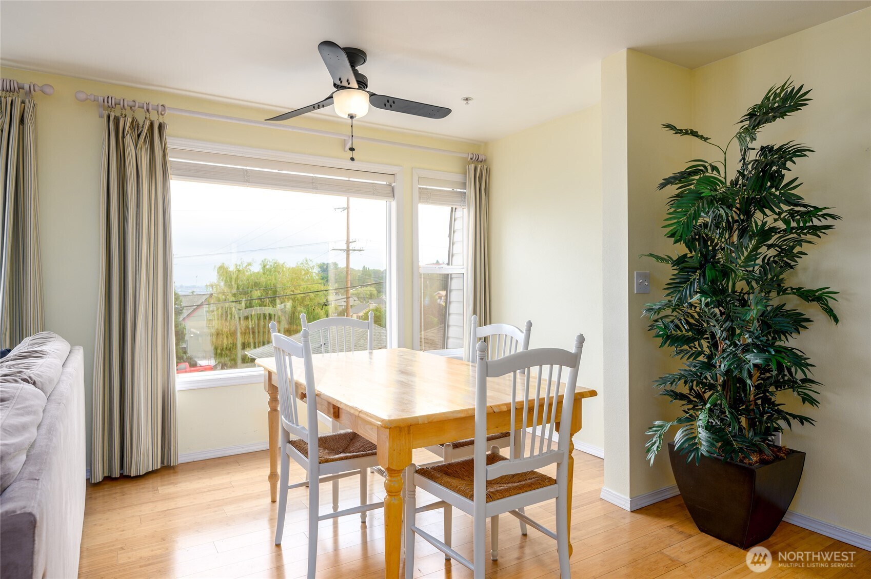 910 34th Street, Unit 202 Anacortes, WA 98221 - Photo 2 of 20 a view of a dining room with furniture window and wooden floor