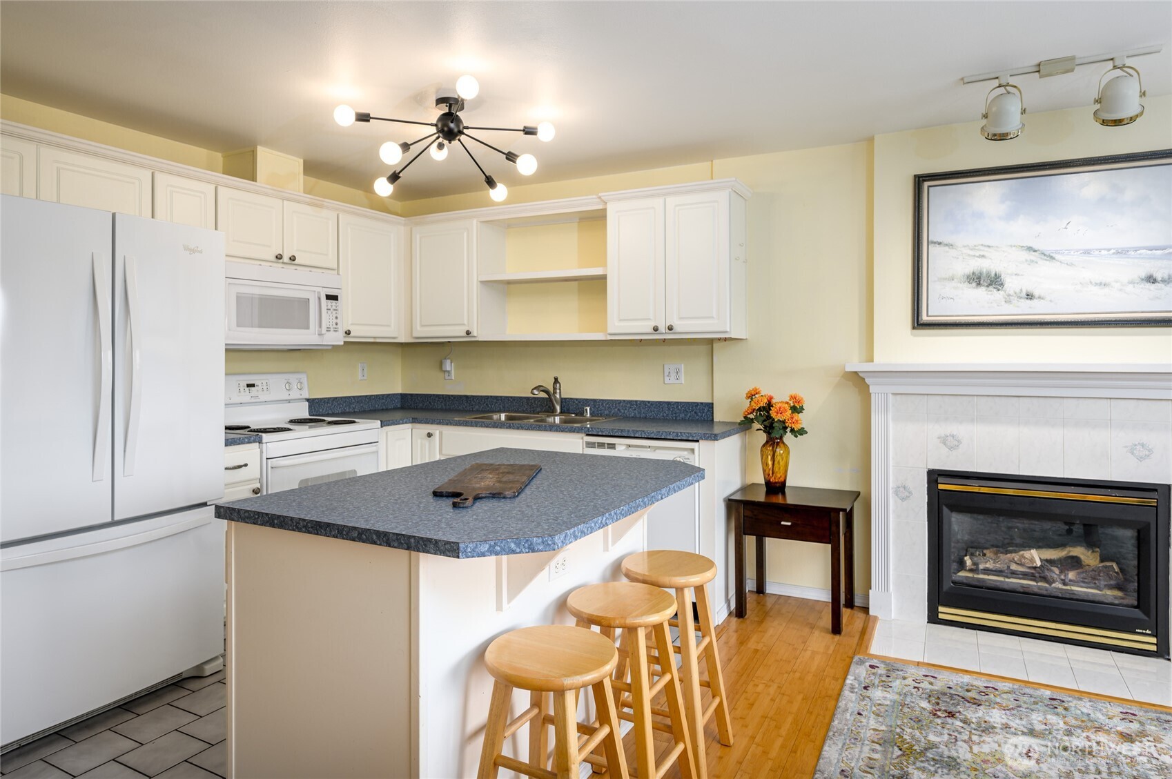 910 34th Street, Unit 202 Anacortes, WA 98221 - Photo 6 of 20 a kitchen with stainless steel appliances granite countertop a stove refrigerator sink and cabinets